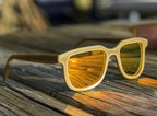 Hemp3D Iris hemp sunglasses in Fire Orange mirror lens on a weathered dock
