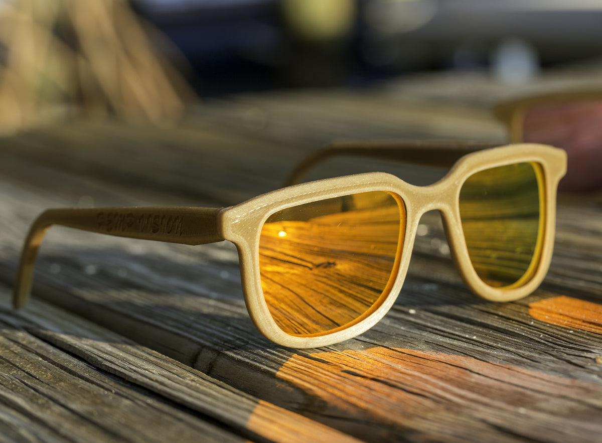 Hemp3D Iris hemp sunglasses in Fire Orange mirror lens on a weathered dock